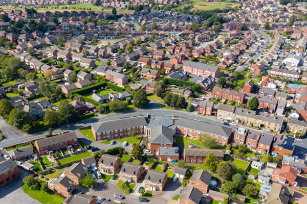 Aerial view of a suburban neighbourhood with houses, streets and trees